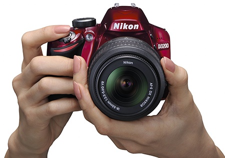 kompaktní Nikon D3200 v rukou
